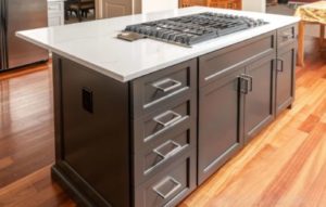 Dark-colored MDF kitchen cabinets with five drawers and three doors